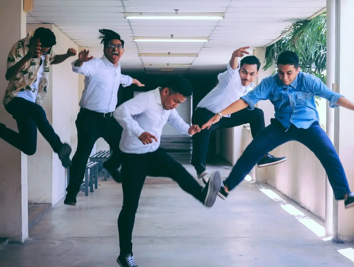 Five office workers jumping up