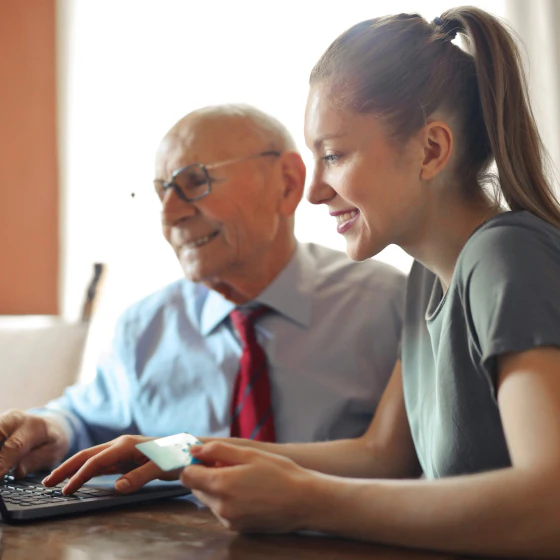 Man and woman purchasing on laptop