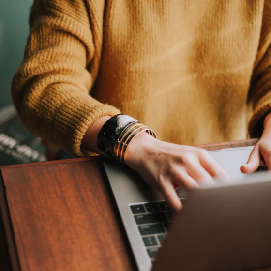 Person on laptop with only hands showing